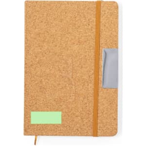 A cork notebook in a natural tan colour featuring an elastic band and a grey pocket on the side.