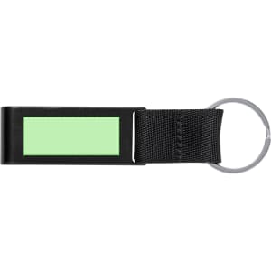 A black keyring with a green rectangular panel and a metal ring for attaching keys or accessories.