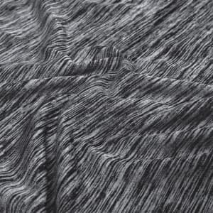 A close-up of textured fabric in shades of black and grey, featuring a modern, abstract pattern.