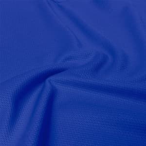 A close-up of a textured fabric in a vibrant blue colour, suitable for polo shirts, featuring a logo.