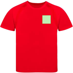 A red children's t-shirt featuring a green square patch. The shirt has a simple design and a logo.