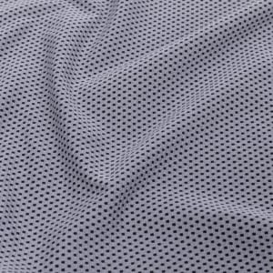 A textured fabric featuring a light grey colour with a subtle pattern of small black dots.