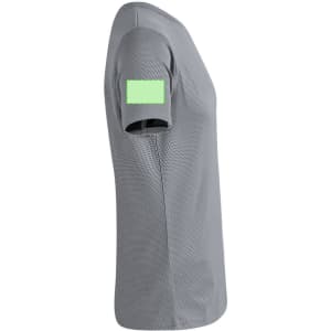 A grey adult T-shirt with a short sleeve featuring a green patch on the shoulder. It has a sporty mesh design.