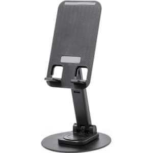 A black phone stand with a textured surface, featuring adjustable support for devices and a round base.
