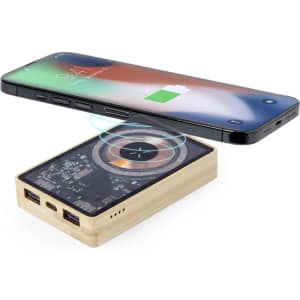A wooden power bank with multiple USB ports, placed below a smartphone displaying a charging symbol.