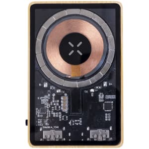 A rectangular power bank with a wooden frame, featuring a circular wireless charging pad and various electronic components.