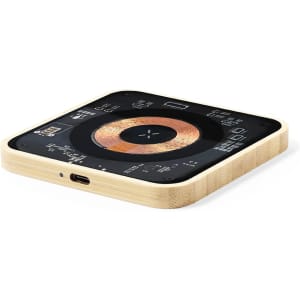 A wireless charger with a square bamboo frame and a black top featuring charging symbols and ports.