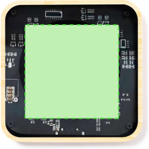 A square wireless charger with a wooden frame and a black circuit board design, featuring a green centre area.