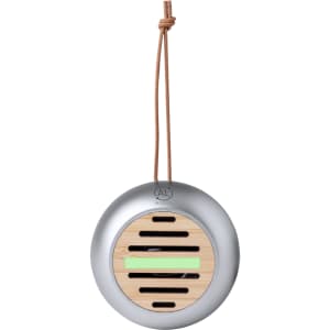 A round, silver speaker with a bamboo front and a leather strap. It features a logo on the top.