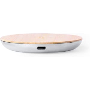 A wireless charger with a wooden top and metallic base, featuring a USB-C port on the side.
