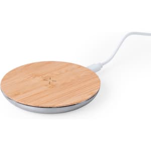 A round wireless charger with a bamboo top and a silver base, connected by a white cable.