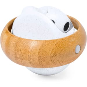 A pair of white earphones nestled in a circular bamboo case. The case features a smooth, natural finish.