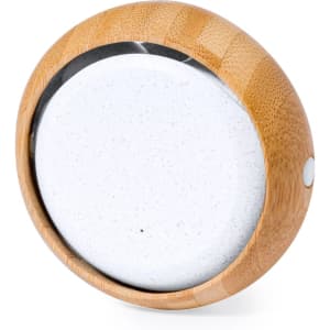 A circular Bluetooth speaker with a bamboo casing and a white speaker grille.