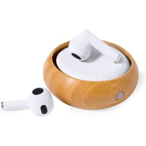 White earphones resting in a round wooden case, with one earphone lying beside it. The case features a subtle logo.