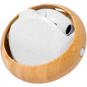A set of white earphones neatly stored in a circular bamboo case. The case features a smooth, natural finish.