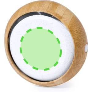 A round speaker with a bamboo exterior and a white, speckled surface, featuring a green circular design on top.