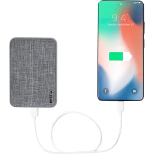 A grey fabric-textured power bank connected to a smartphone displaying a charging icon.