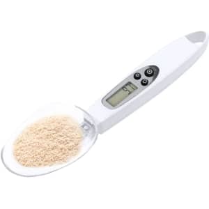 A white digital weighing scale with a clear scoop containing powdered substance. It features buttons and a digital display.
