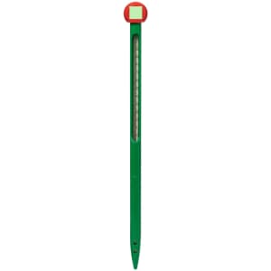 A green soil thermometer with a red top, designed for measuring soil temperatures in outdoor settings.