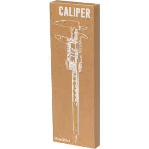 A caliper in a cardboard packaging, featuring a logo and an illustration of the tool. The packaging has a brown colour.