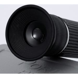 A black Jekux refractometer with a textured grip and a round eyepiece, placed on a surface.