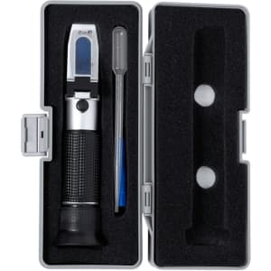 A silver and black refractometer enclosed in a grey case, accompanied by a pipette and storage compartments.