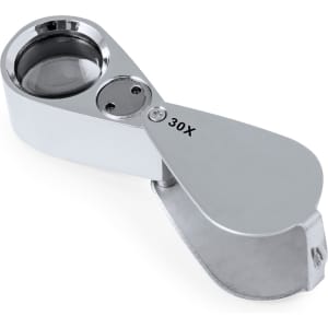 A shiny chrome 30X magnifier with a foldable design, featuring a circular lens and a hidden compartment.