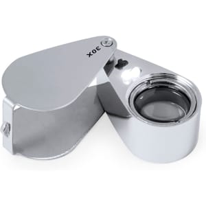 A chrome 30X magnifier with a hinged cover and built-in light. Compact and sleek in design.