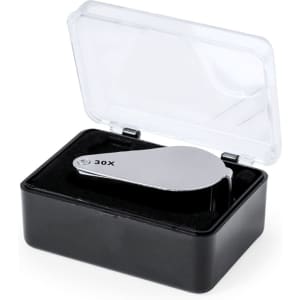 A 30X magnifier in a black case with a transparent lid, featuring a sleek, silver magnifying lens inside.