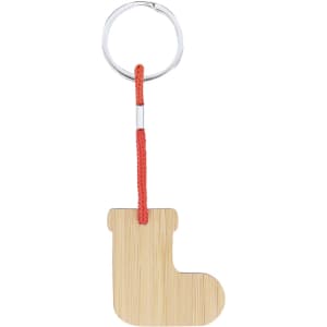 A bamboo keyring shaped like a boot attached to a silver keyring with a red cord.