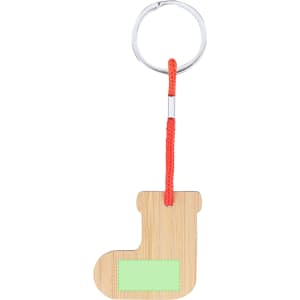 A bamboo keyring shaped like a boot, featuring a green label and an orange cord. Includes a metal ring for attachment.