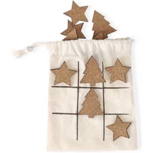 A cotton drawstring bag containing cork star and tree pieces arranged in a tic-tac-toe format.