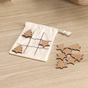 A cotton pouch featuring a tic-tac-toe grid, with wooden cork pieces shaped like stars and Christmas trees.