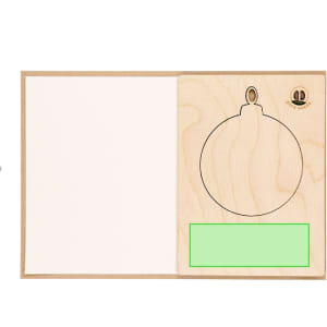 A wooden Christmas card decoration featuring a circular ornament outline on one side and a blank space for a message.