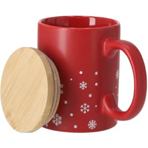 A red coffee mug with white snowflake patterns and a bamboo lid. It features a sturdy handle and a smooth finish.