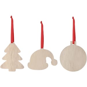 Three wooden Christmas decorations in the shapes of a tree, a hat, and a circle, with red hanging ribbons.