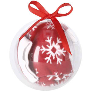 A transparent ball contains a pair of red socks with white snowflake patterns, tied with a red ribbon.