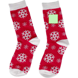Red socks with white snowflake patterns and white cuffs, featuring a blank green area.