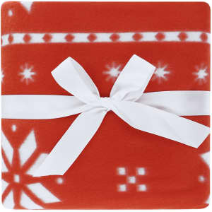 A red blanket with a white ribbon, featuring a snowflake pattern. The blanket has a soft, fleece texture.