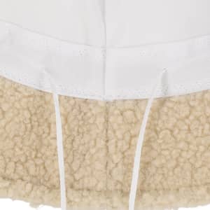 A beige beanie with a fluffy texture at the bottom and a smooth white top section, featuring a logo.