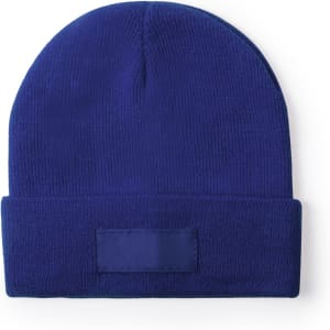 A blue beanie with a folded cuff and a blank patch for branding.