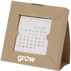 A desk calendar with a kraft paper frame displaying a monthly layout in white and green. Features a logo.