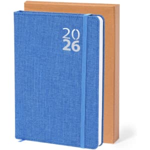 A blue diary with the year 2026 on the cover, resting against a brown diary. Both have a logo on them.