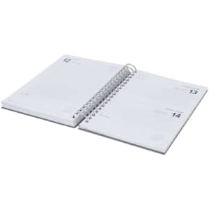 A spiral-bound diary with white pages and space for daily entries, organised by date. It features a logo on the cover.