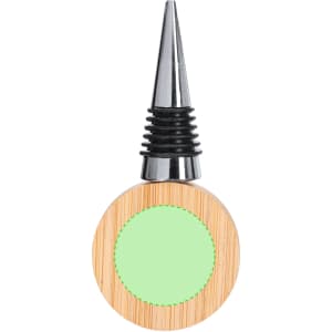 A drink bottle opener in natural wood with a green circular area, featuring a metallic nozzle and black rubber stopper.