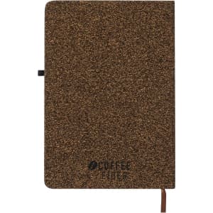 A brown notepad with a textured cover and an attached ribbon bookmark, featuring a logo.