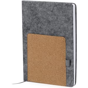 A grey notepad with a cork pocket on the front, featuring a ribbon bookmark and a flexible cover.