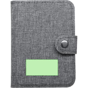 A grey fabric wallet with a snap closure and a blank green label on the front. Features a logo.