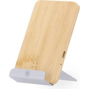 A wireless charger with a bamboo finish and a grey stand, featuring a logo on the front.