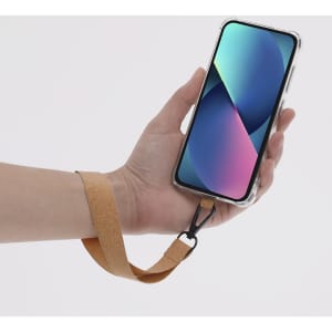 A tan holder bracelet is attached to a smartphone, enhancing grip and convenience while holding it.